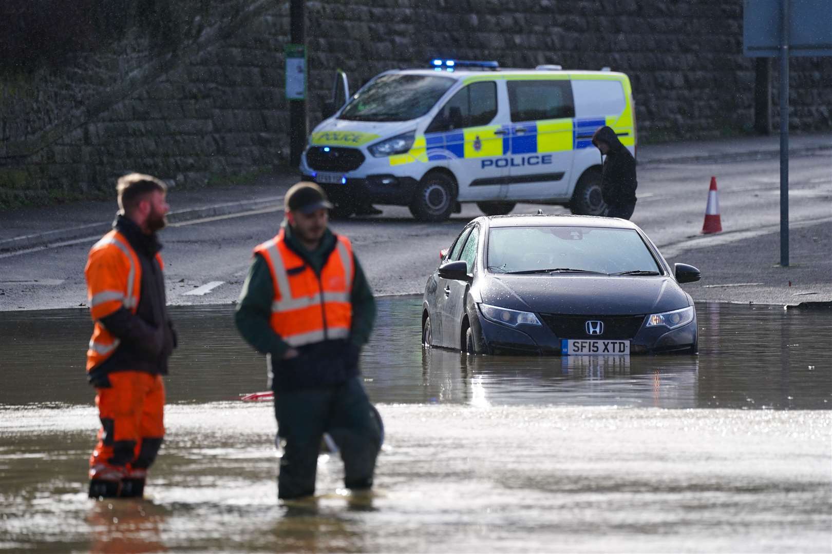 A stranded vehicle in flood water in Belper (Jacob King/PA)