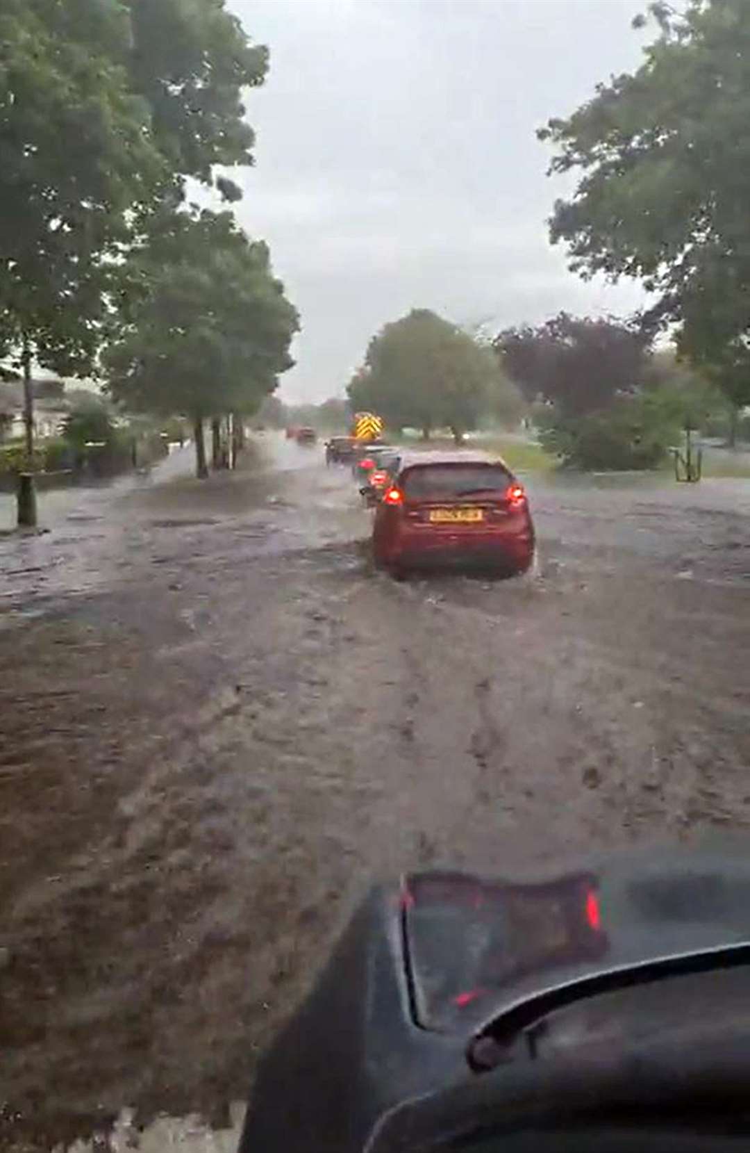 Cars going through flooding on the Great Western Road, near Drumchapel, after heavy rain in Glasgow on Saturday (@maryparker2605/PA)