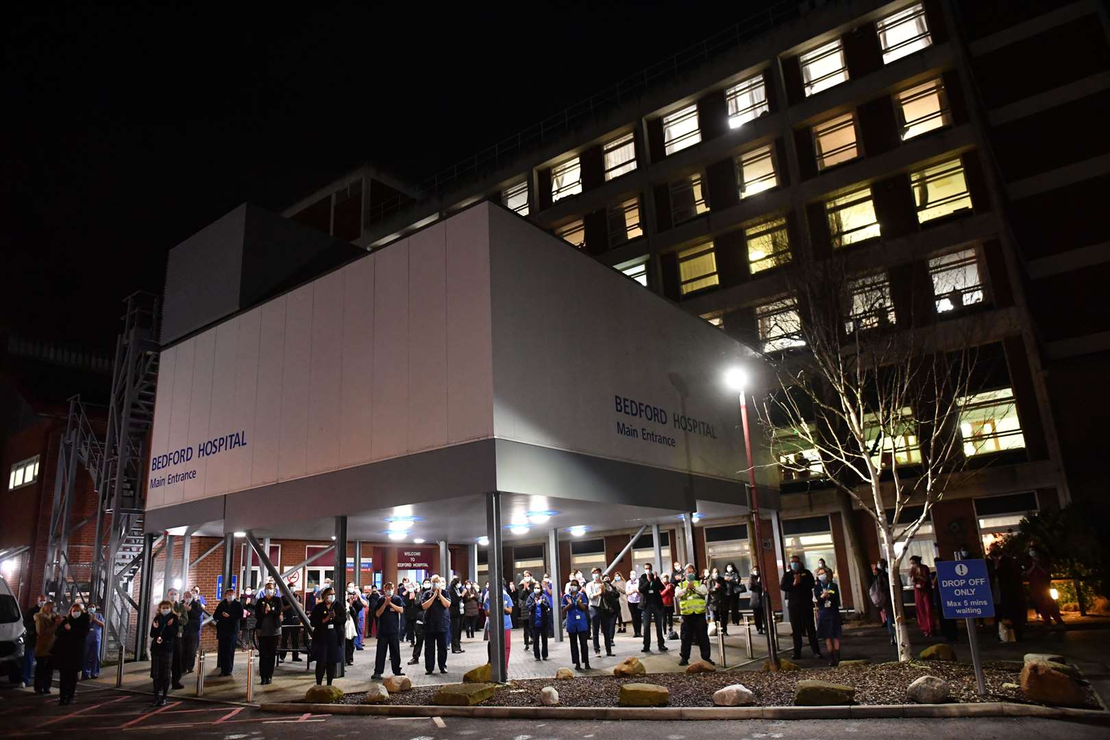 NHS staff outside Bedford Hospital join in with a nationwide clap in honour of Captain Sir Tom Moore (Jacob King/PA)