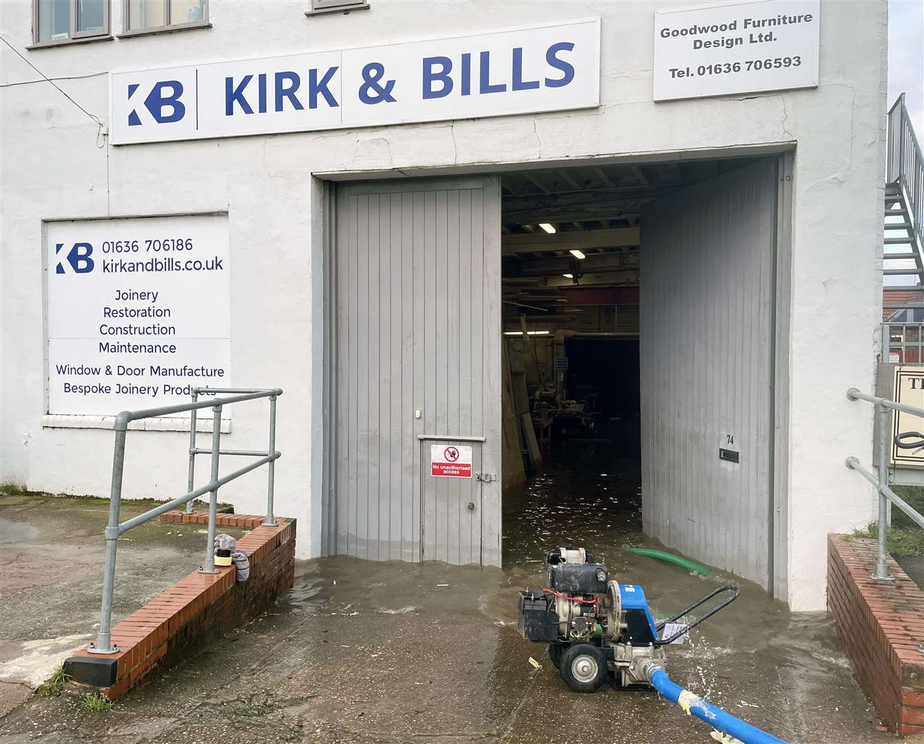 Floodwater being pumped out of a furniture workshop in Newark-on-Trent (Callum Parke/PA)