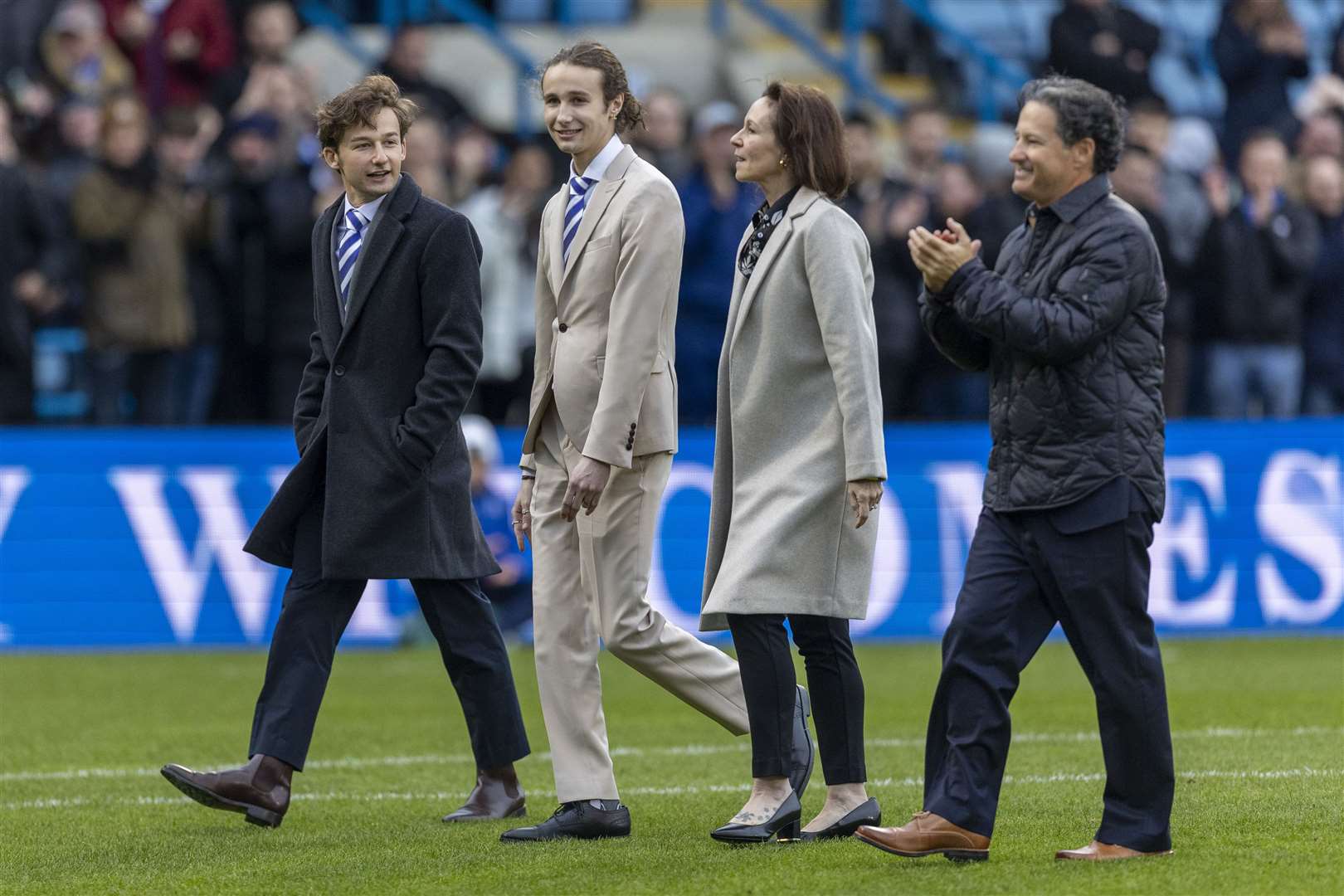 Brad Galinson and his family on the pitch before kick off