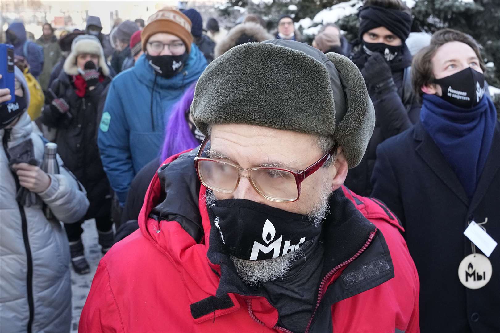 Supporters of the Memorial human rights group wearing face masks with the words “The Memorial cannot be banned!” gather in front of the Moscow Court (Alexander Zemlianichenko/AP/PA)