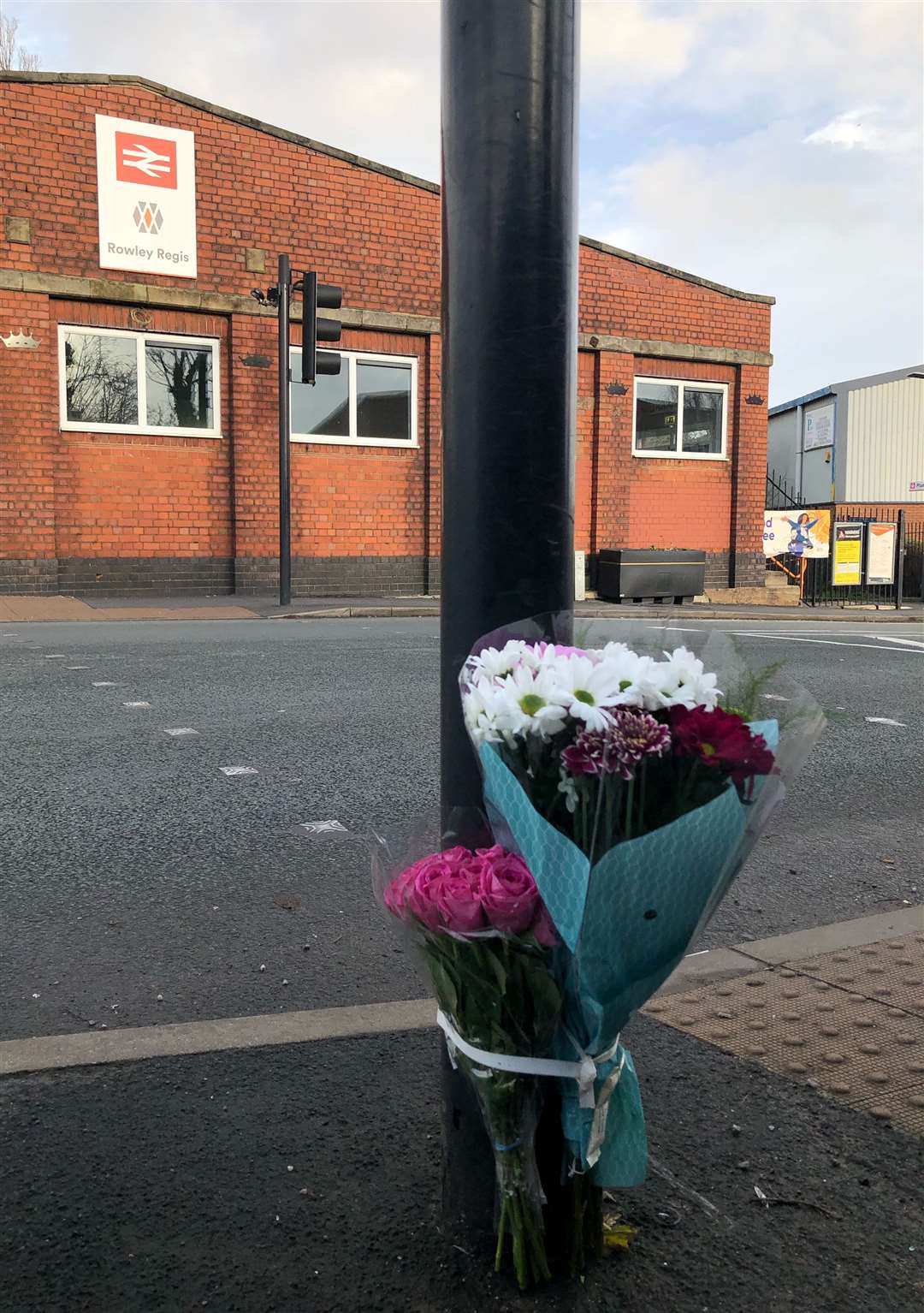 Flowers attached to traffic lights at a pedestrian crossing near Rowley Regis station in the West Midlands, after the death of a 14-year-old girl who was hit by a car on New Year’s Eve (Matthew Cooper/PA)