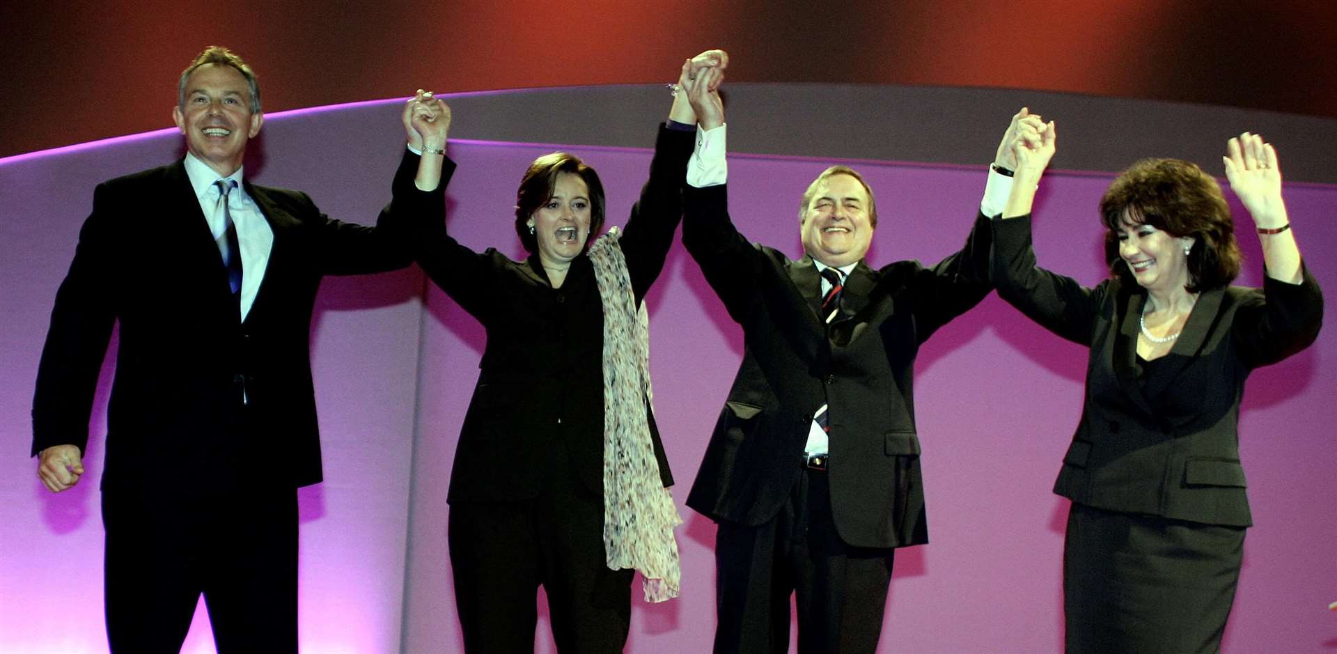 Then- prime minister Tony Blair and wife Cherie join then-deputy PM John Prescott and wife Pauline on stage (Andrew Parsons/PA)