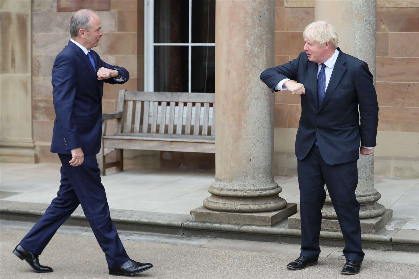 Boris Johnson (right) and Taoiseach Micheal Martin greet each other with an elbow bump at Hillsborough Castle during the Prime Minister’s visit to Belfast last August (Brian Lawless/PA)