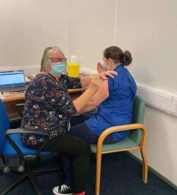 Darent Valley Hospital nurse Marian Mitchell vaccinates her own daughter and fellow nurse Miranda Paddy (43754862)