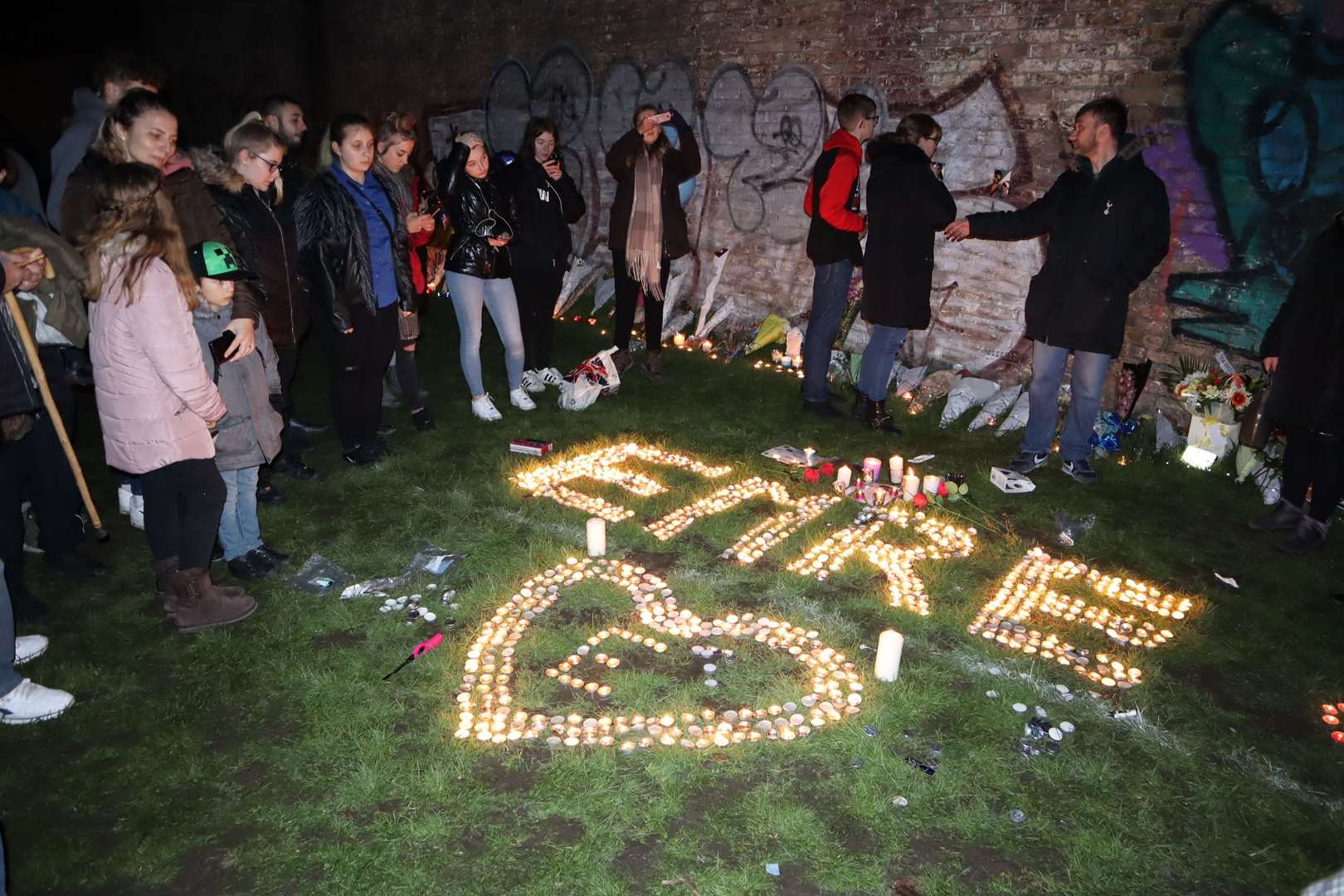 Friends gather at the candlelit vigil for Emre Huseyin in New Road playing fields, Sheerness, on Thursday. It would have been his 16th birthday