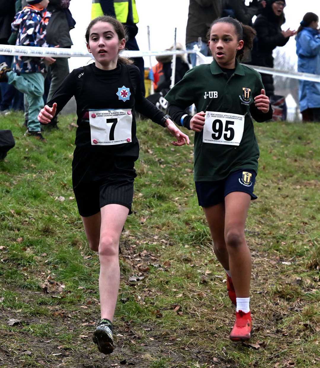 No.7 Alice Bunn for Bexley with No.95 Jalia Ungufe-Bailey of South East Kent in the Year 7 girls’ race. Picture: Simon Hildrew