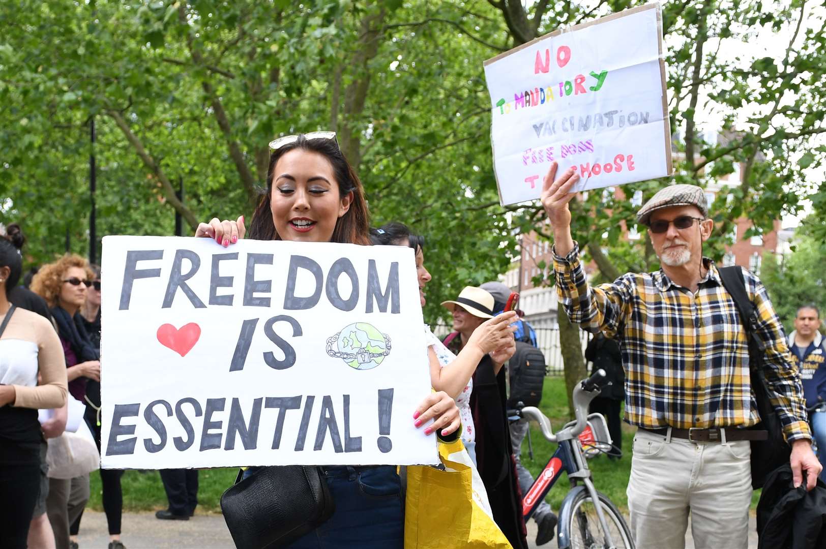 A protester in Hyde Park in London after the introduction of measures to bring the country out of lockdown (Stefan Rousseau/PA)