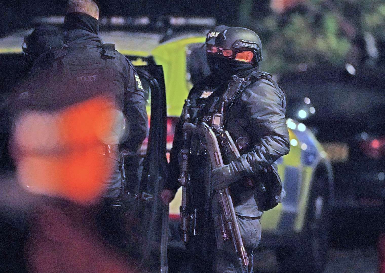 An armed police officer holds a breaching shotgun, used to blast the hinges off a door, at an address in Rutland Avenue in Sefton Park in the early hours of Monday (Peter Byrne/PA)