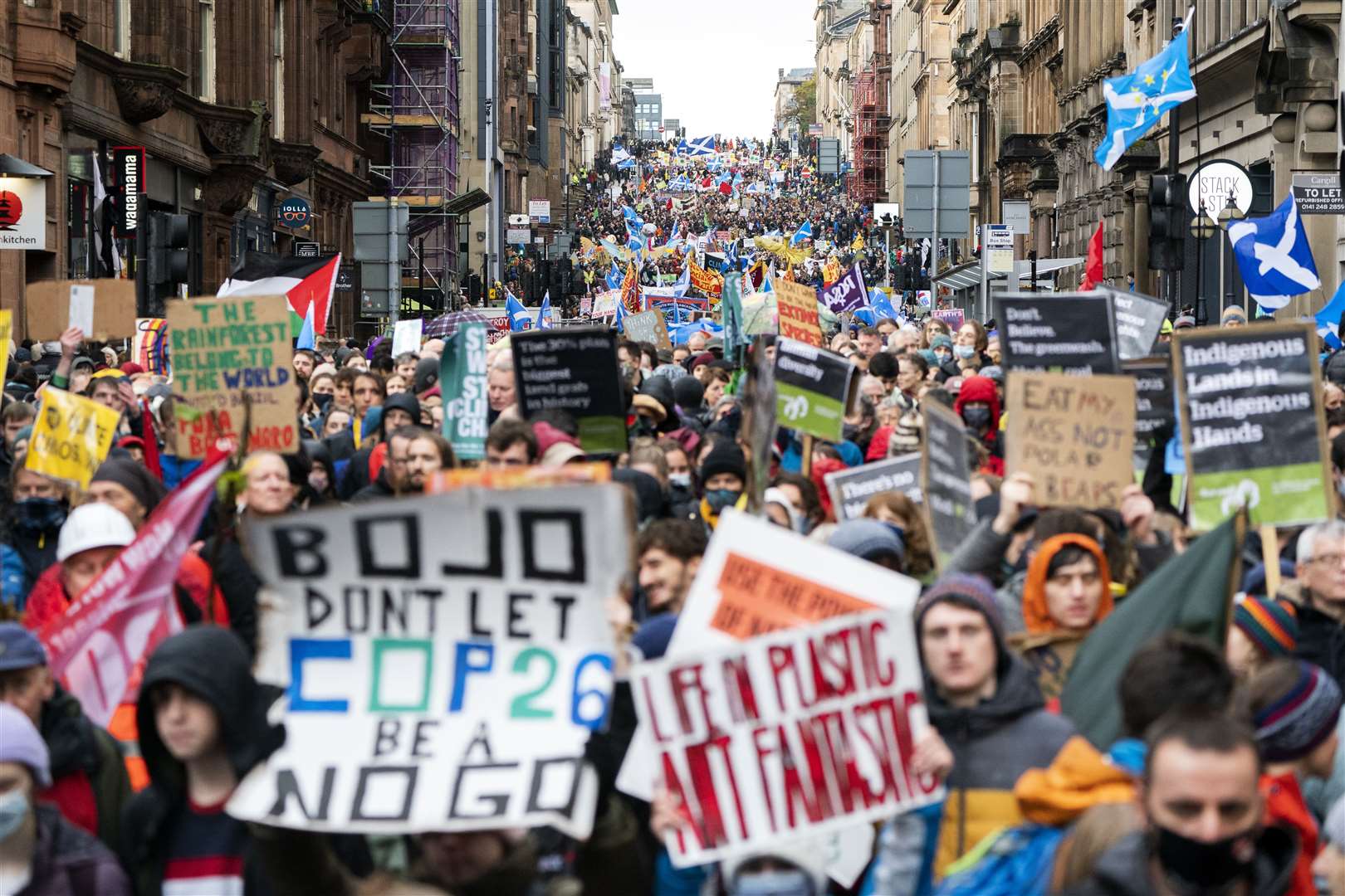 Climate campaigners marched through Glasgow at the halfway point of the Cop26 summit (Jane Barlow/PA)