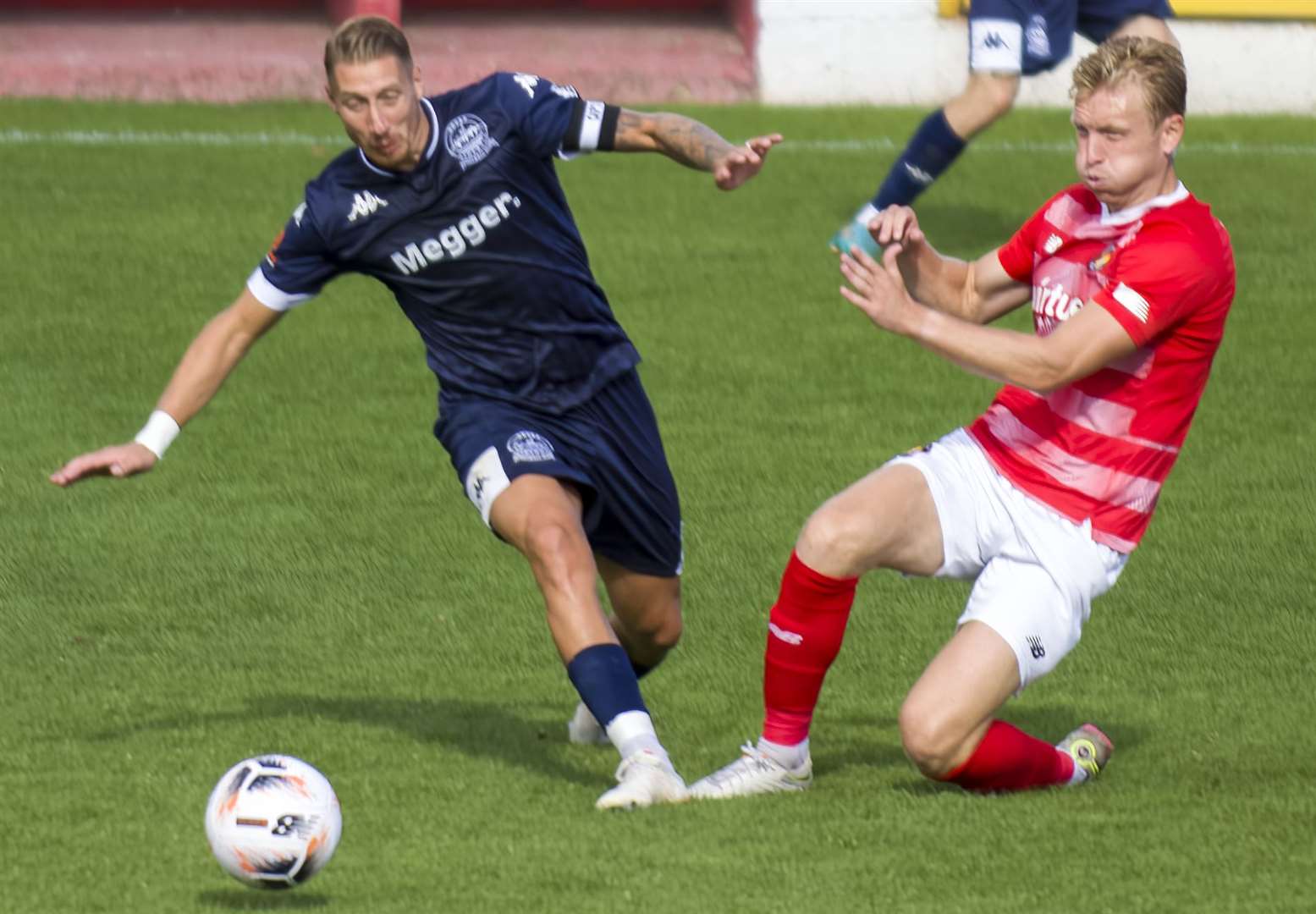 Josh Wright slides in against former Fleet man Lee Martin. Picture: Ed Miller/EUFC