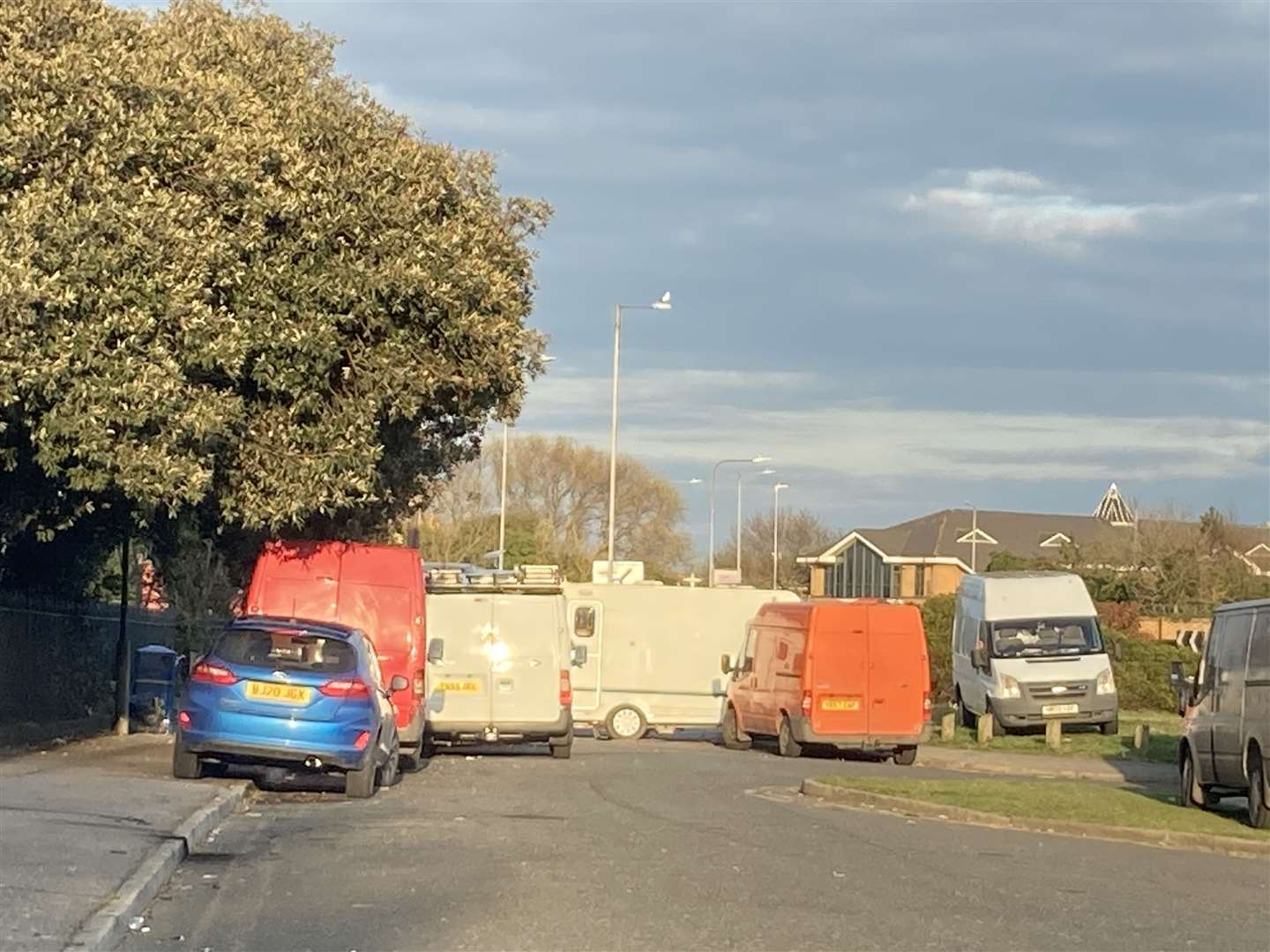 Travellers vans at the entrance of Blue Town near historic Naval Terrace