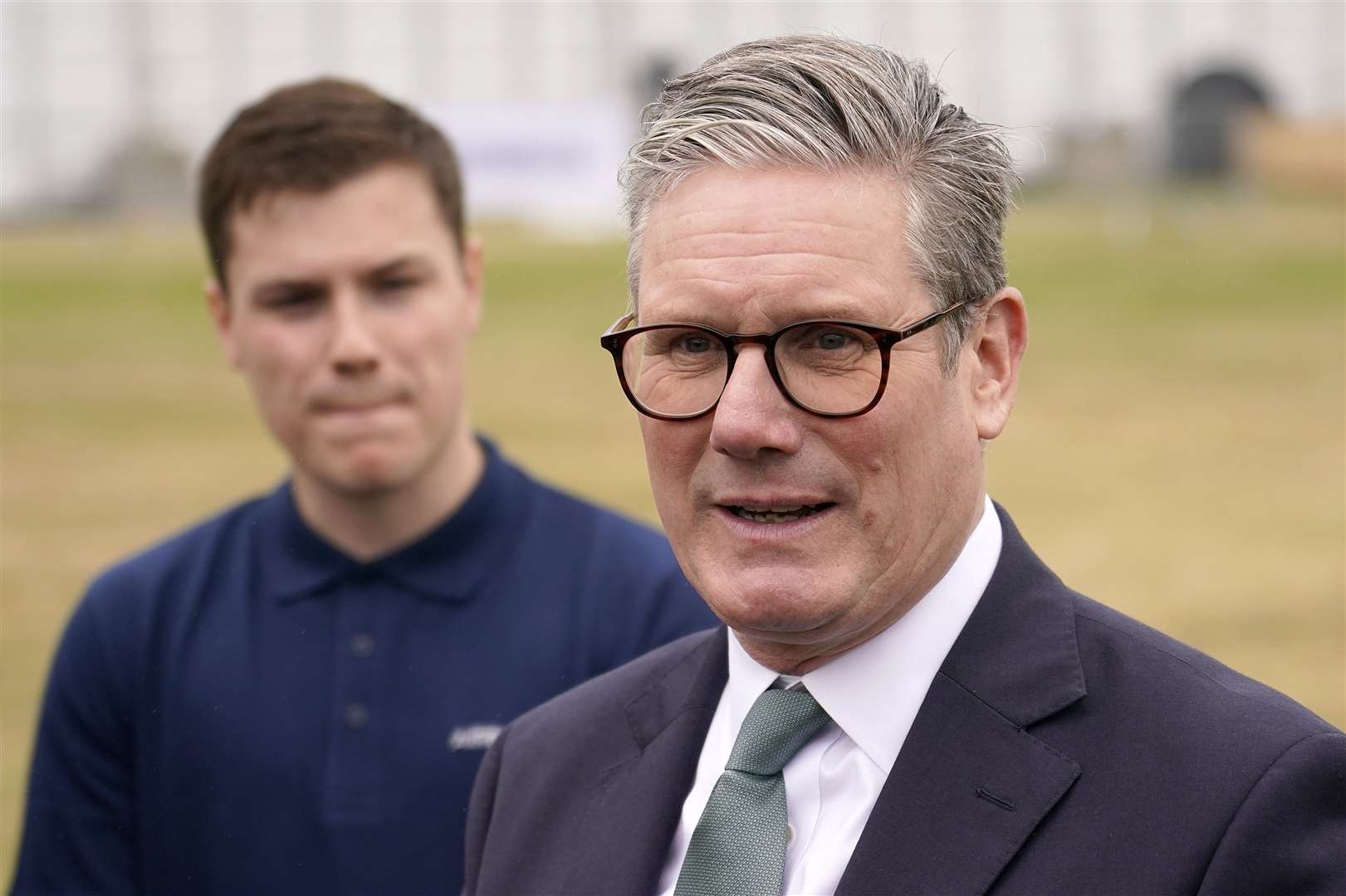 Prime Minister Sir Keir Starmer speaks to employees, as he arrives at the Farnborough International Airshow (Alberto Pezzali/PA)