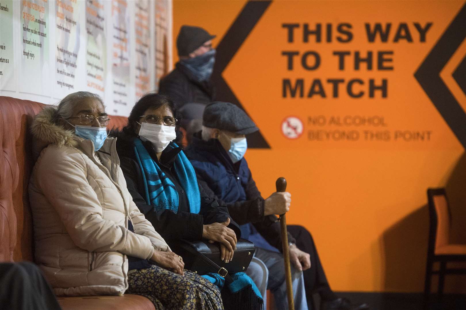 Patients prepare to receive the first of two injections with a dose of the Pfizer/BioNtech Covid-19 vaccine at The Hive in Harrow (Kirsty O’Connor/PA)