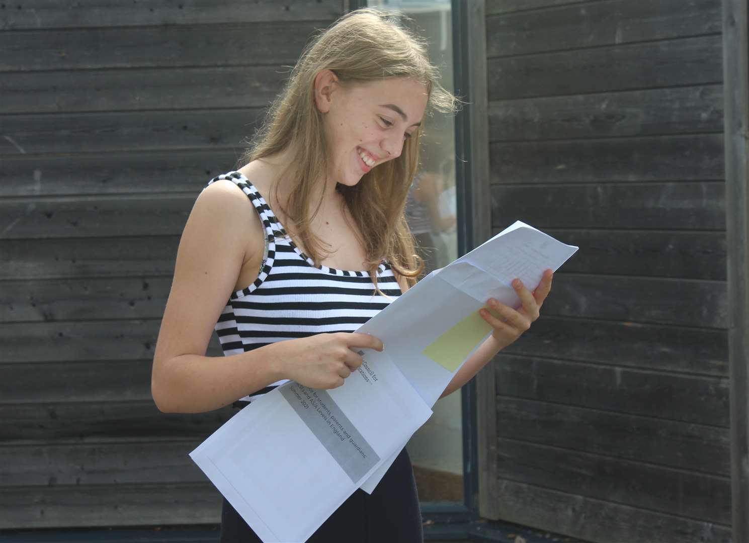 A pupil at Highsted Grammar School for Girls, Sittingbourne, checks her GCSE results