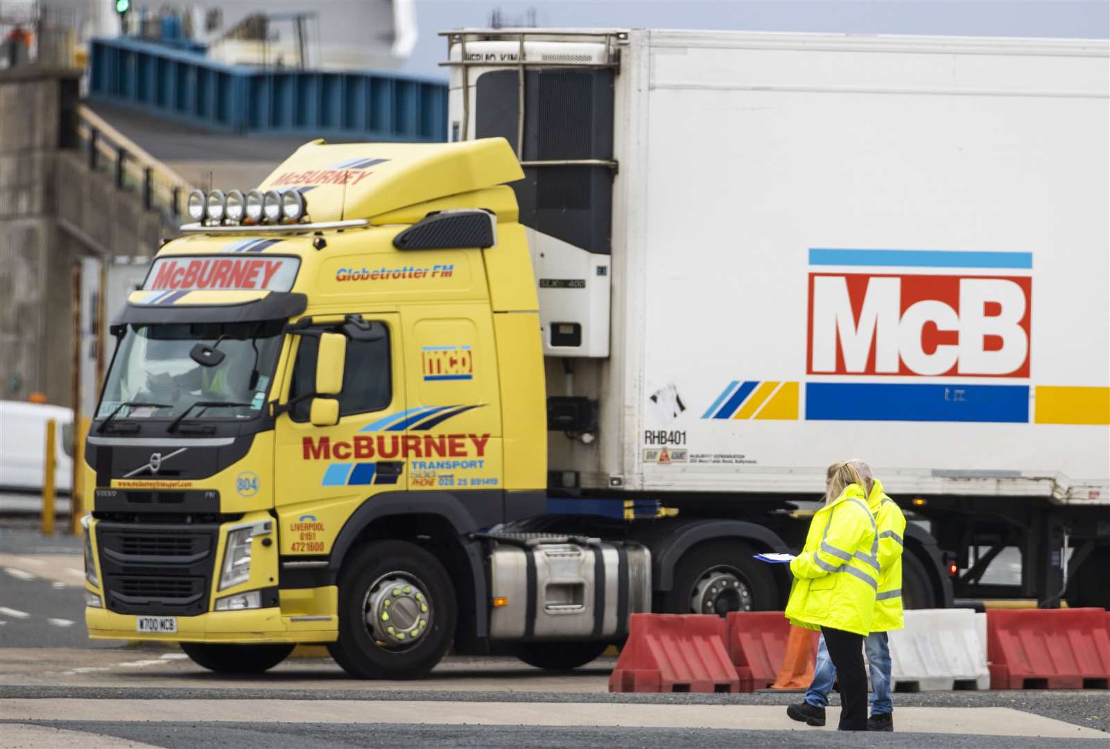 Officials at Larne Port as vehicles disembark a ferry from Cairnryan in Scotland (Liam McBurney/PA)