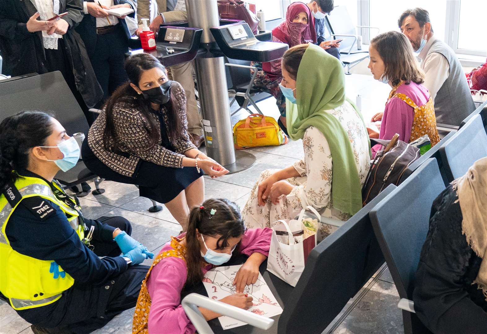 Home Secretary Priti Patel talking to Malalai Hussiny, a refugee from Afghanistan who arrived on a evacuation flight (Dominic Lipinski/PA)