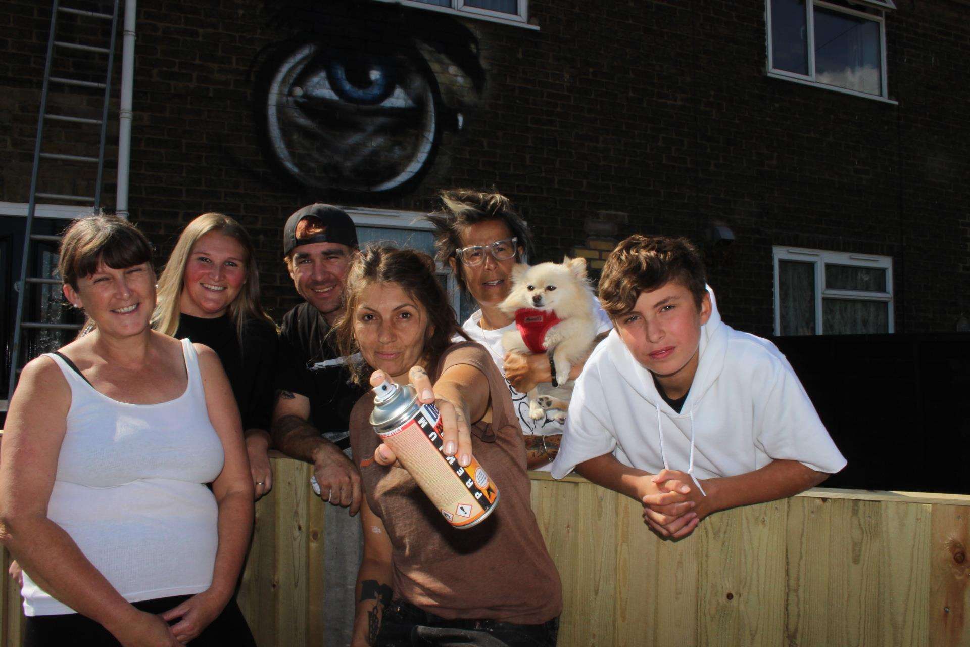 Muralist Jules Muck, centre, from the USA after she turned Denise Kerry's home in Medway Road, Sheerness, into a mural of Harry Potter