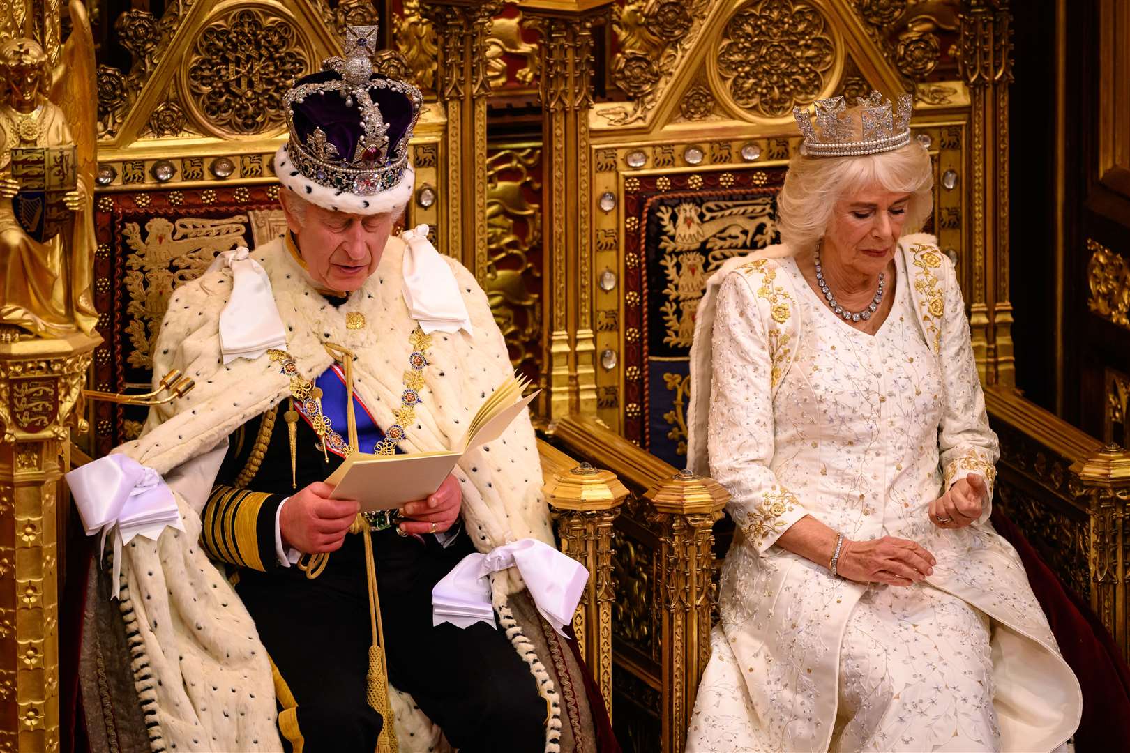 The King delivers his speech beside the Queen during the State Opening of Parliament in the House of Lords (Leon Neal/PA)