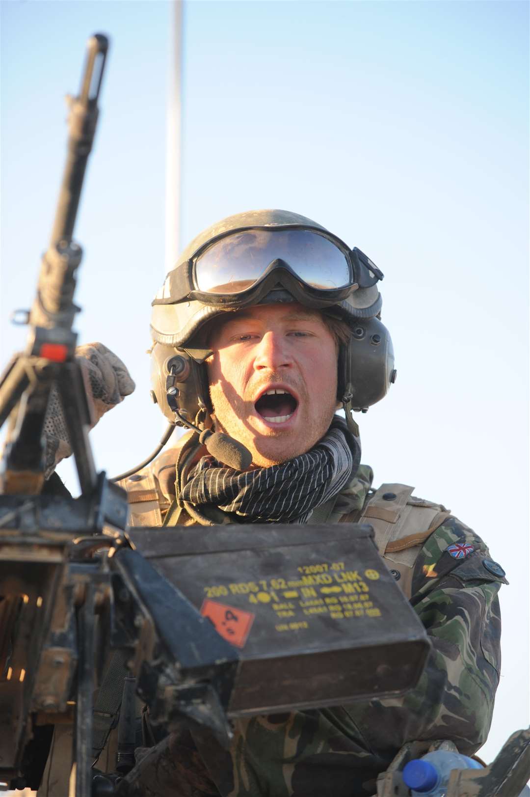 Harry speaks on the radio from the turret of his Spartan armoured vehicle in the desert in Helmand province in southern Afghanistan (John Stillwell/PA)