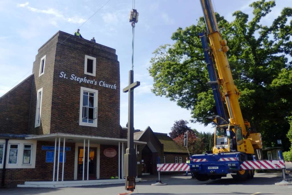 The cross lowered to the ground.