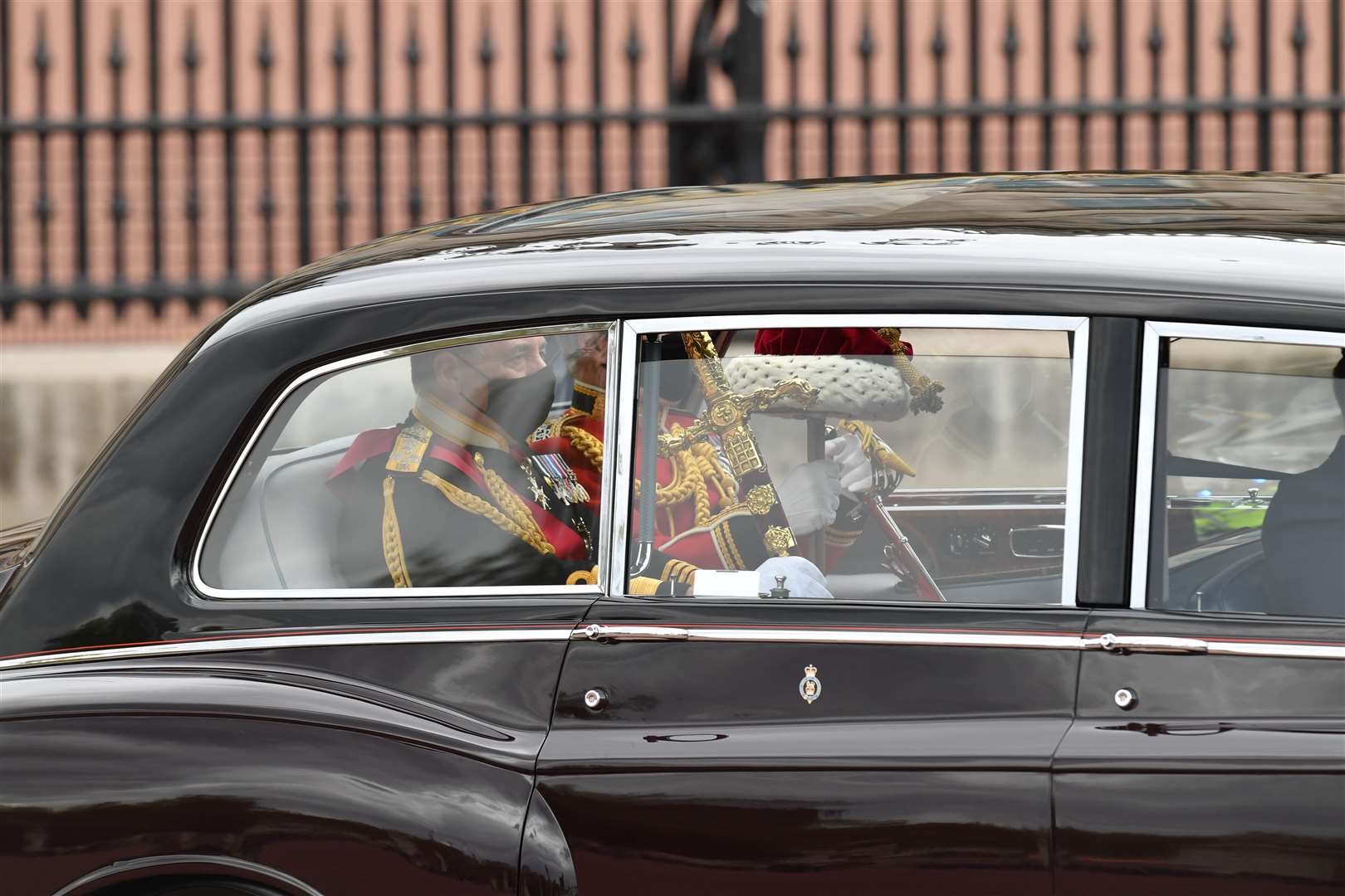 The Sword of State, left, leaves Buckingham Palace for the State Opening of Parliament in 2021 (PA)