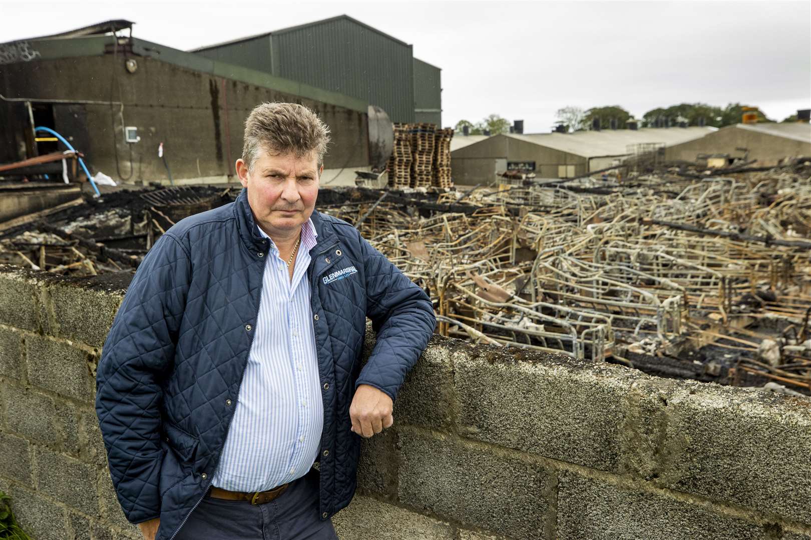 Trevor Shields stands beside the remains of an overnight fire at his farrowing house at Glenmarshal Pedigree Pigs (Liam McBurney/PA)