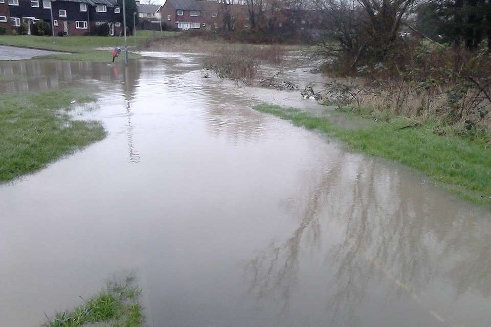 A path disappears under rain water. Stock image