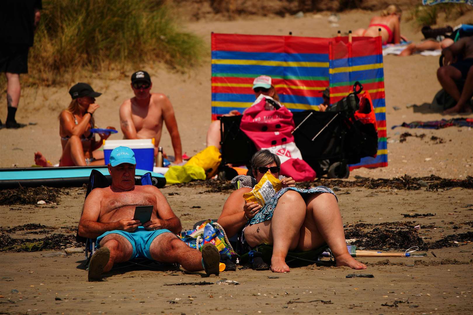 People relaxing on the beach at St Michael’s Bay in Cornwall (Ben Birchall/PA)