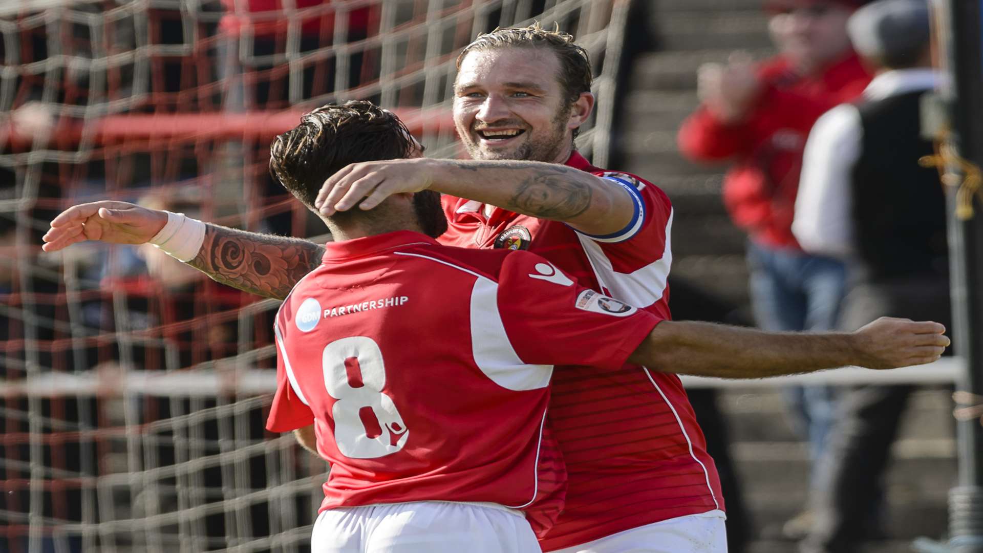 Danny Kedwell celebrates scoring his spot-kick with Sam Deering. Picture: Andy Payton