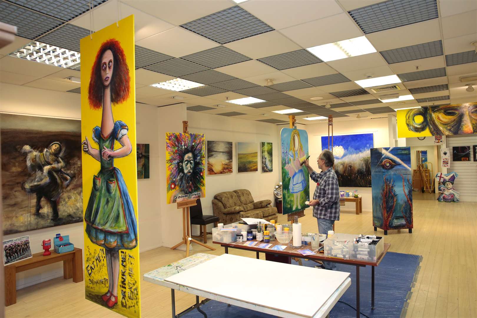 Artist Stephen Oliver at the easel in his Orchard Shopping Centre studio.