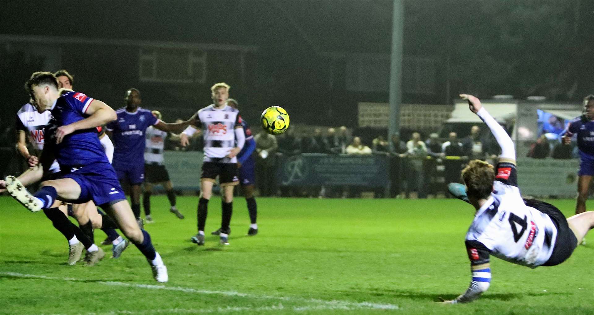 Deal defender Alfie Foster tries his luck with a spectacular injury-time strike as Margate's Lewis Knight puts his body on the line. Picture: Paul Willmott