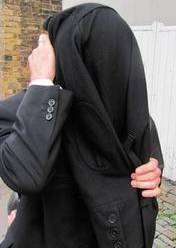 Carl Underdown hides his face as he leaves Canterbury Magistrates Court last Wednesday