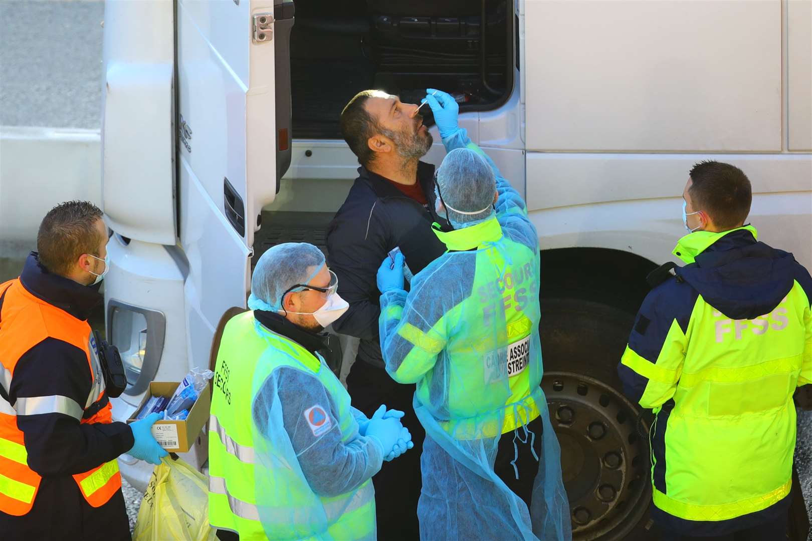 A man conducts a Covid-19 test on a driver at the Port of Dover (Aaron Chown/PA)