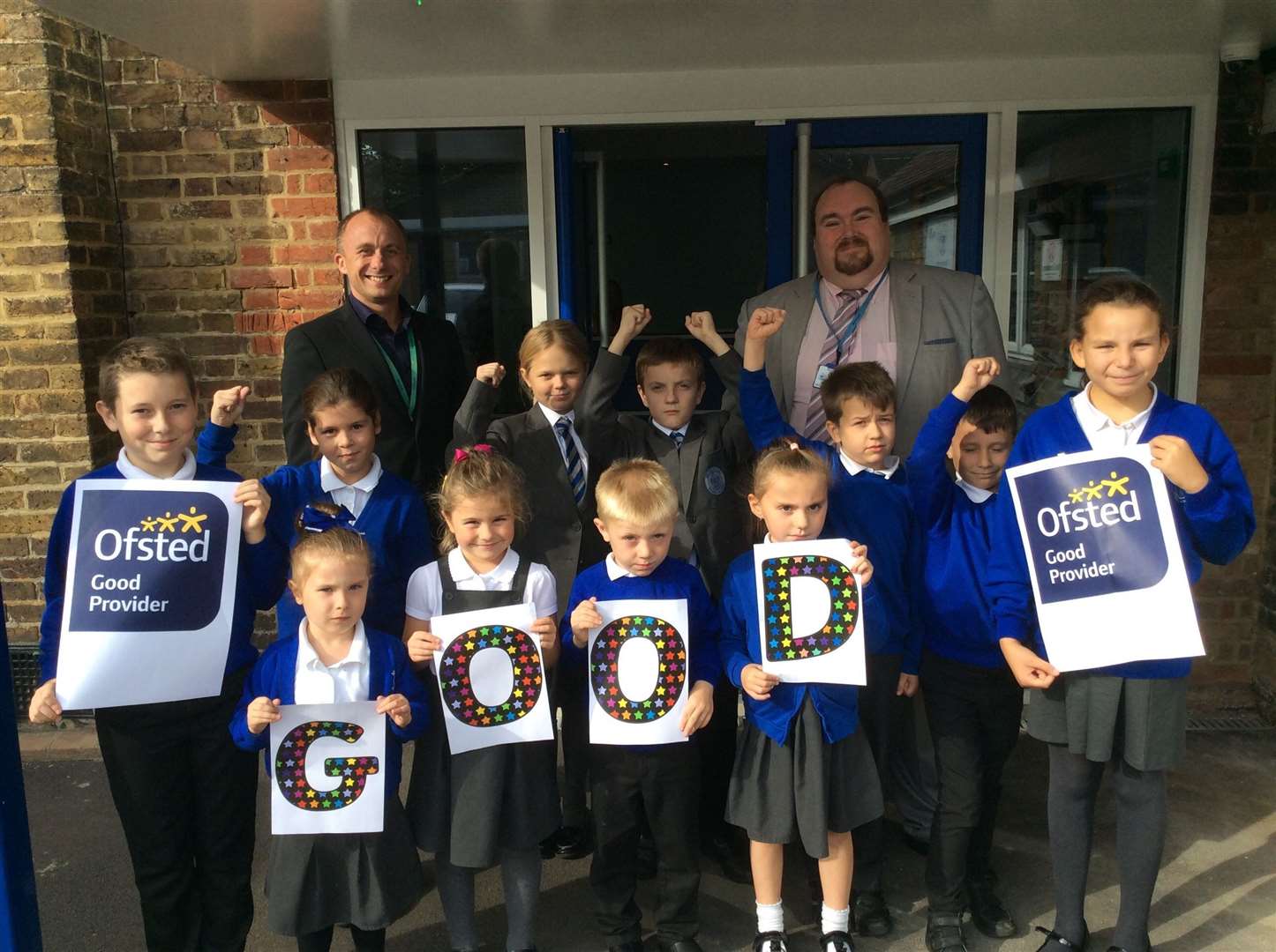 Deputy head teacher Ben Clark and head teacher Anthony Cosans celebrating Milton Court Primary Academy's 'good' Ofsted report with the children.