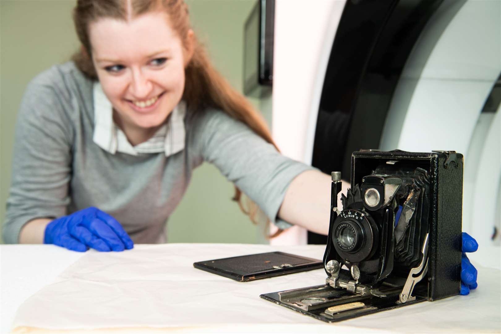 Eleanor Durrant, conservator, National Science and Media Museum, positioning the ‘Cameo’ camera on the NewTom CBCT (Cone Beam CT) scanner (University of Bradford/PA)