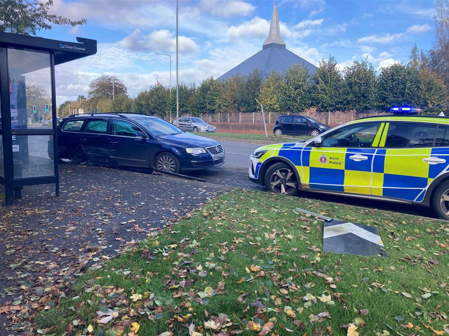 A Volkswagen is also parked nearby and has damage to its back passenger door