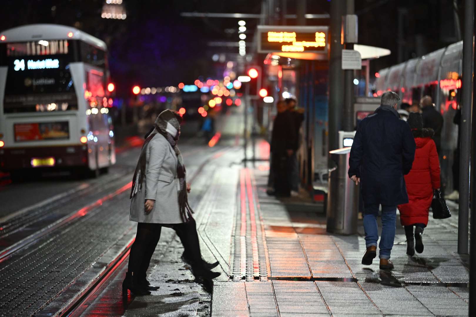 People on the near-deserted Princes Street in Edinburgh after all outdoor events including the street party and fireworks display planned for Edinburgh’s New Year were cancelled due to bad weather. (PA)