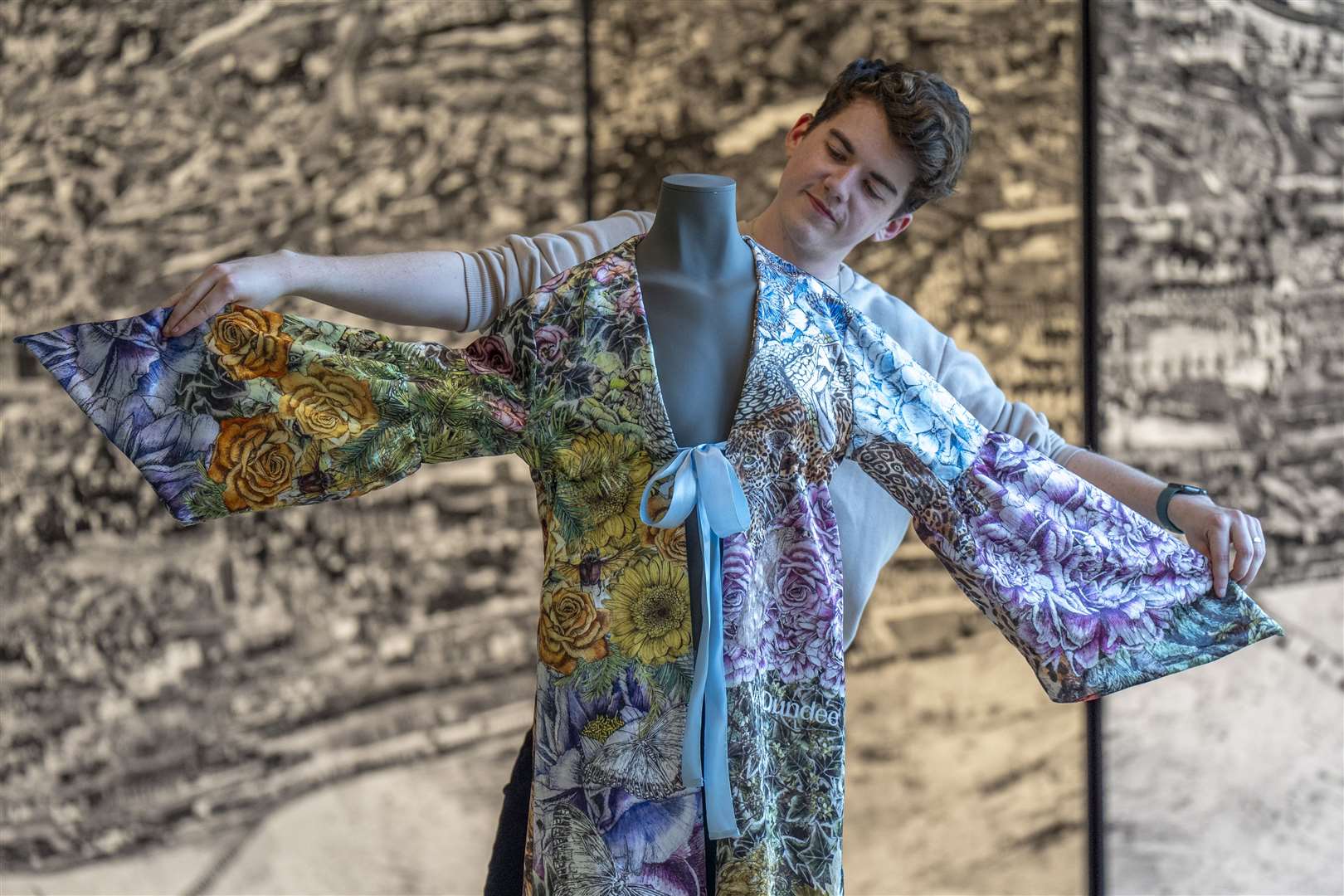 Museum content manager Chris Keatch takes a closer look at a kimono inspired by Taylor Swift’s music (Jane Barlow/PA)