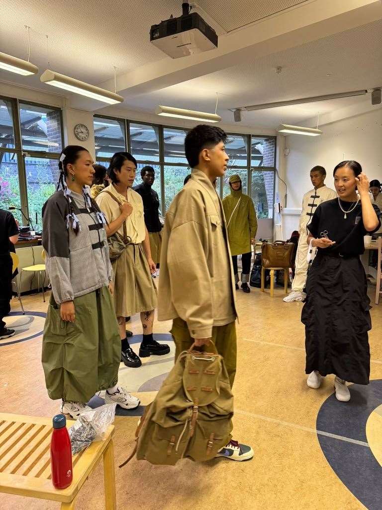 The founder of fashion brand Sum London, Margaret Sam, backstage with models of mixed Malaysian, Korean and British heritage ahead of her runway at the Museum of the Home (Margaret Sam/PA)