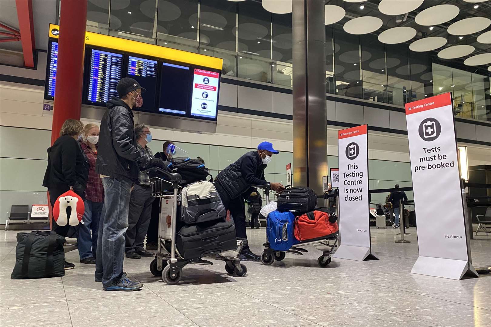 Passengers waiting in line outside the testing centre at London’s Heathrow Airport (Kirsty O’Connor/PA)