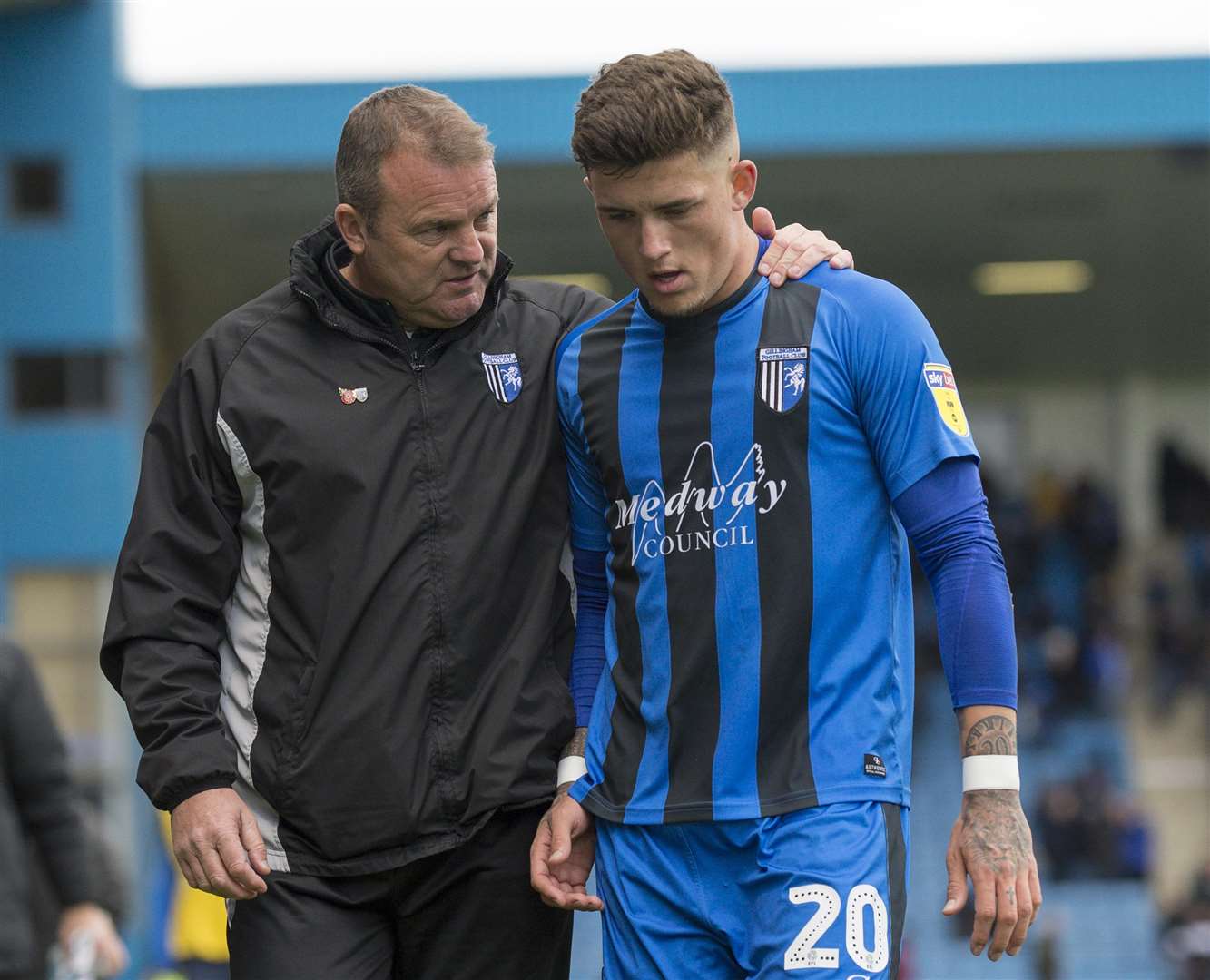Assistant boss Mark Patterson talks to Gillingham's Darren Oldaker as they walk off at half-time on Saturday. Picture: Ady Kerry