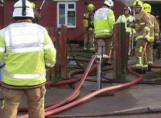 Firefighters tackling a blaze. Stock image