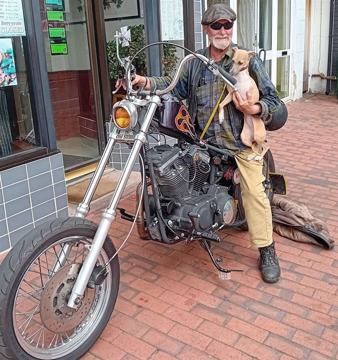 Robert with his three-legged dog Lucy on Ian Maggs' Harley-Davidson chopper. Picture: Ian Maggs