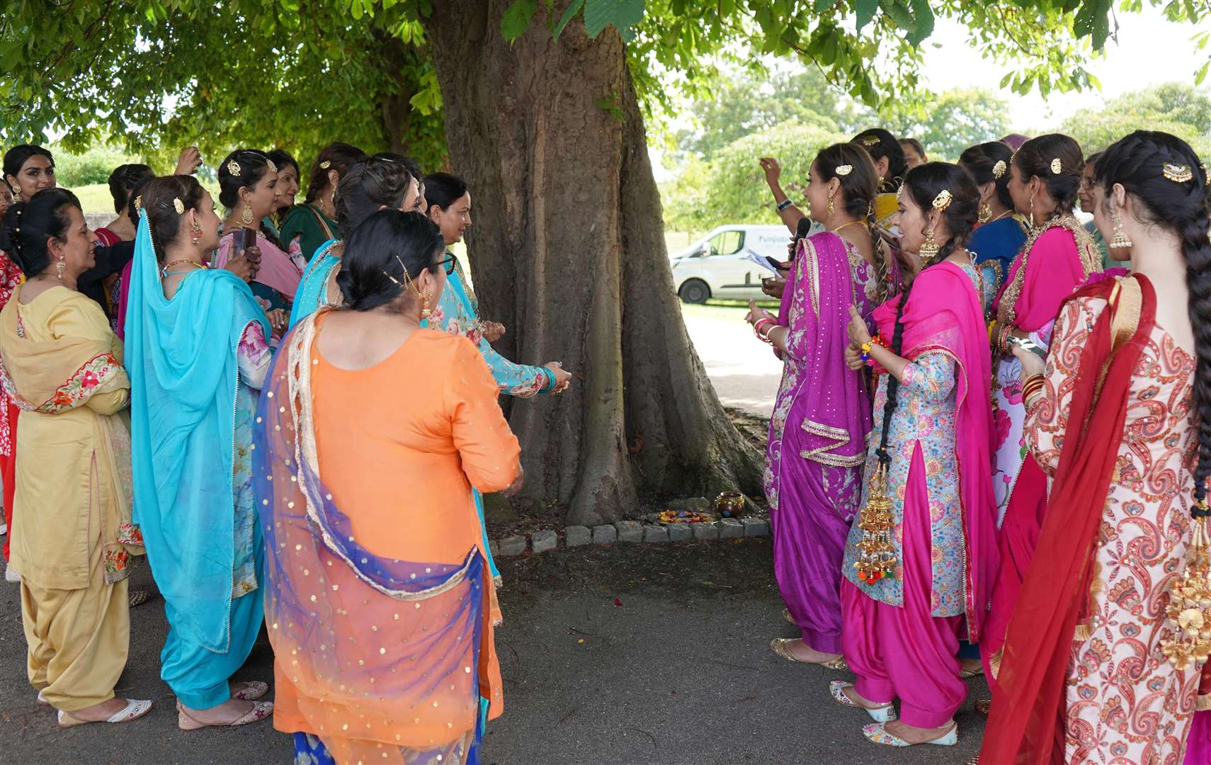 Women open the festival by praying for prosperity and health around a tree. Photo: Aman Rattan