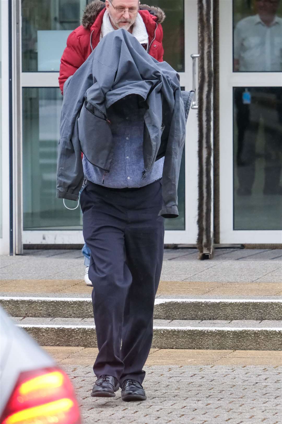 Timothy Schofield covers his head as he leaves Exeter Crown Court (Matt Keeble/PA)