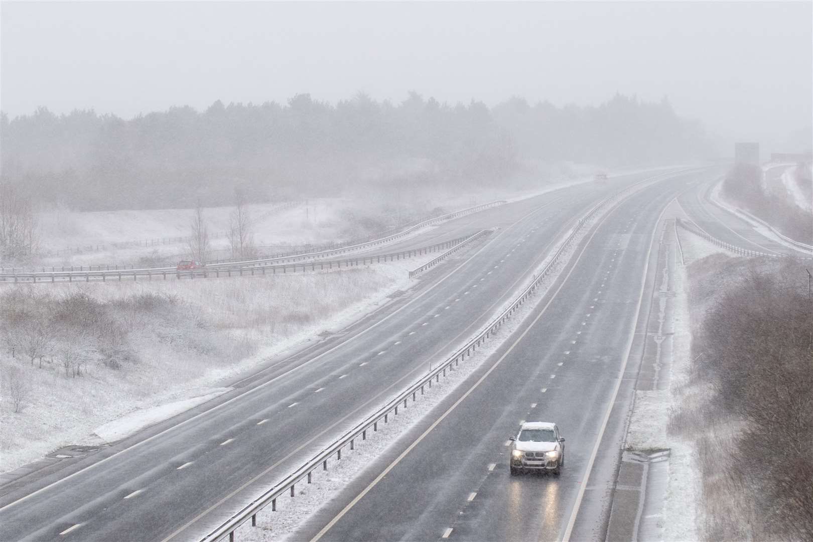 Snow falls on the A14 near Stowmarket in Suffolk (Joe Giddens/PA)