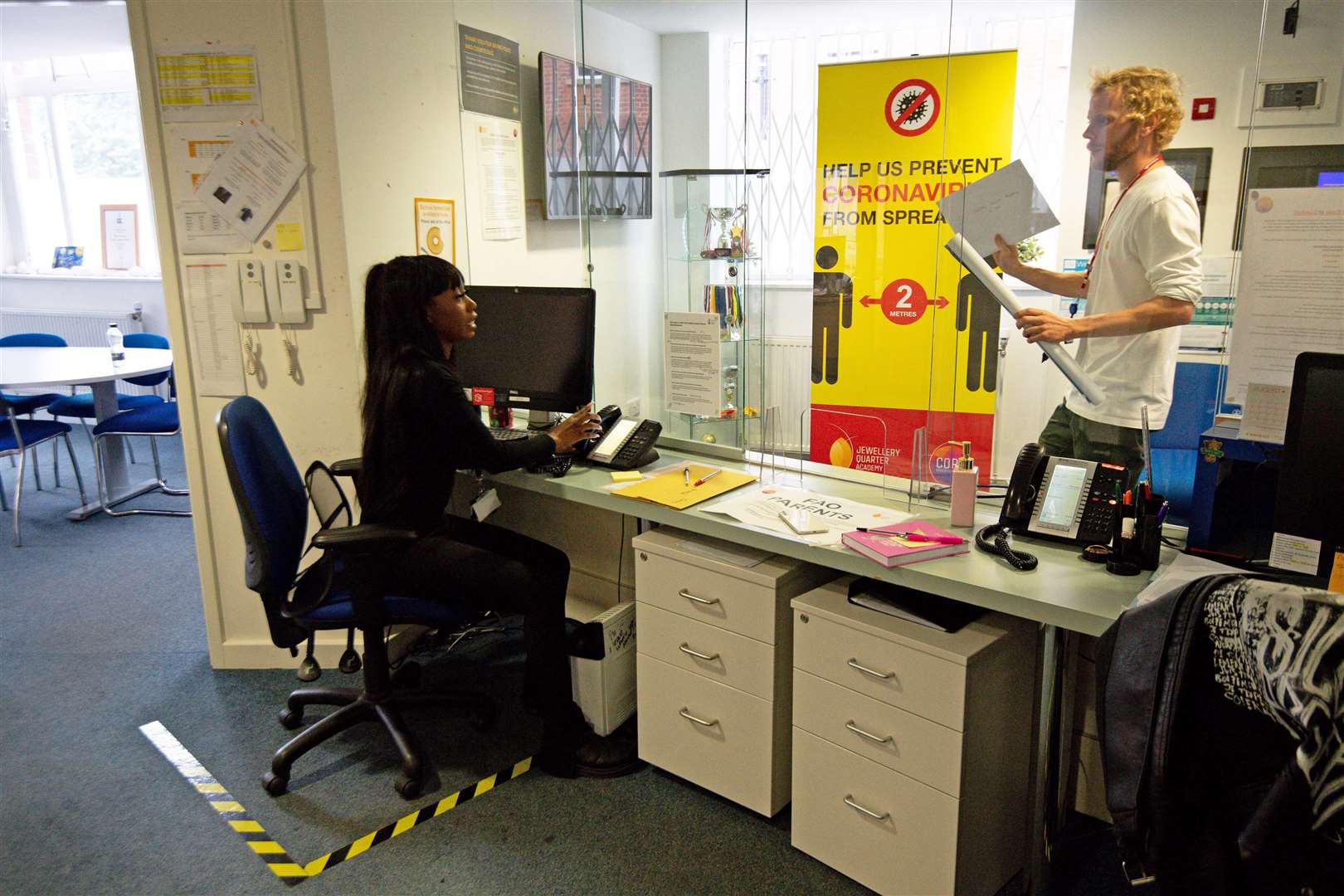 Social distancing markings and screens are up in the school’s reception area (Jacob King/PA)