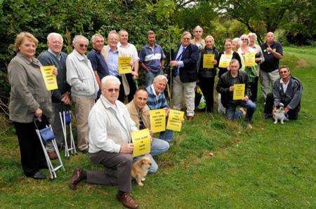 Ken Ingleton, centre, planting a tree in celebration.